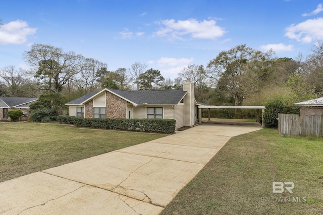 view of home's exterior with concrete driveway, a lawn, a chimney, and a carport