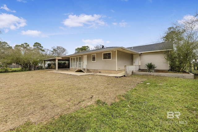 rear view of house with a patio and a lawn