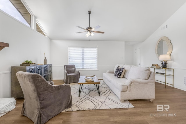 living area with visible vents, baseboards, ceiling fan, and wood finished floors