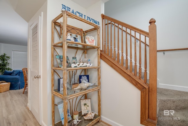 stairway featuring baseboards and wood finished floors