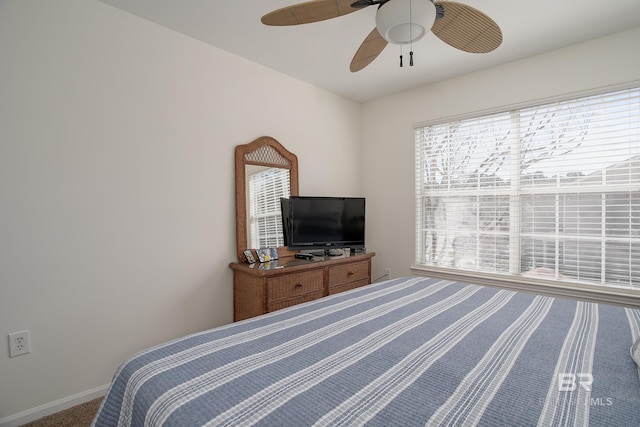 bedroom featuring baseboards, multiple windows, and ceiling fan