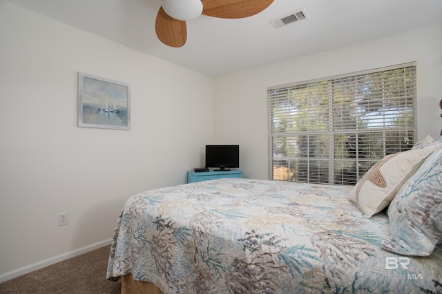 carpeted bedroom featuring visible vents, ceiling fan, and baseboards