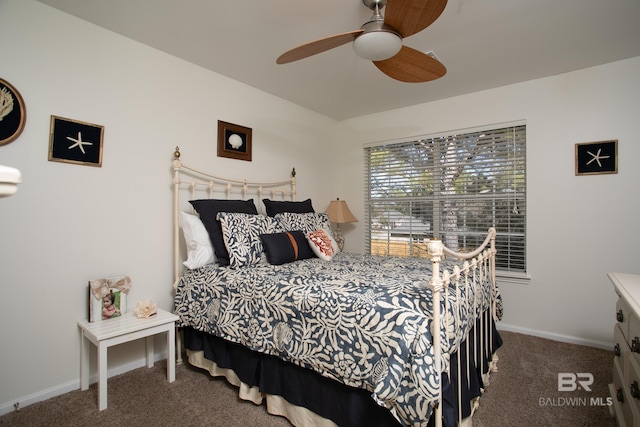 carpeted bedroom featuring baseboards and ceiling fan