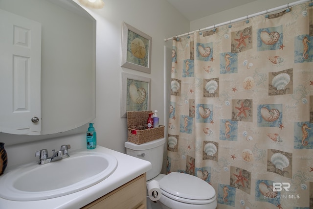 bathroom with vanity, curtained shower, and toilet