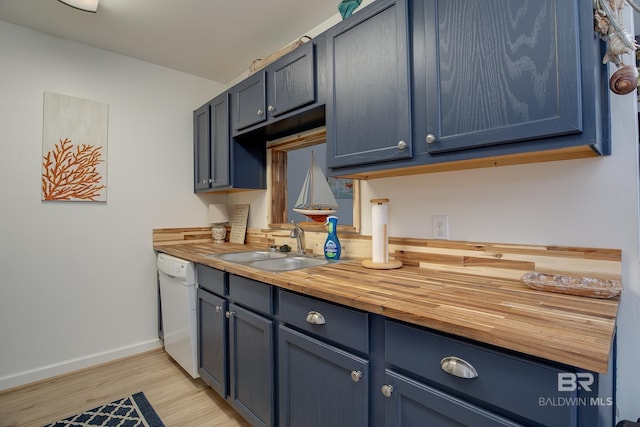 kitchen with a sink, wood counters, dishwasher, blue cabinets, and light wood-type flooring