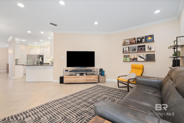 living room featuring ornamental molding and light tile patterned floors