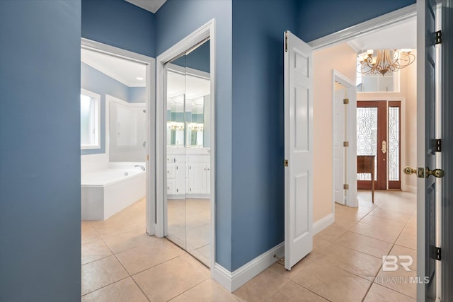 corridor featuring a notable chandelier and light tile patterned floors