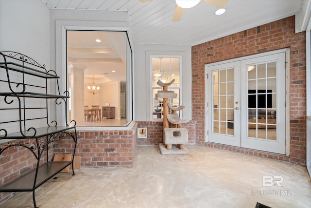 sunroom / solarium with ceiling fan with notable chandelier and french doors