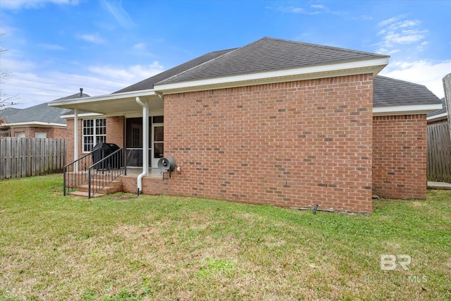 rear view of house with a lawn