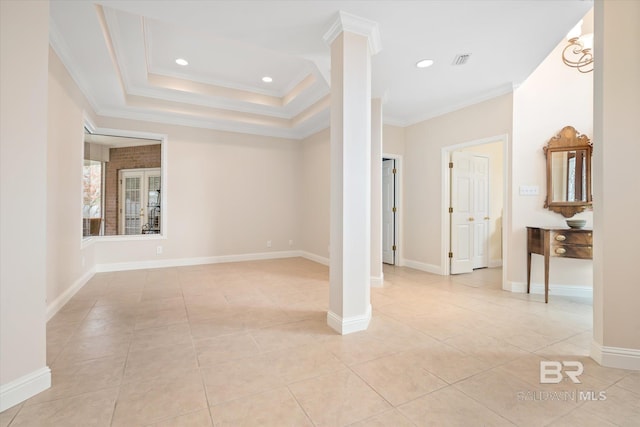 spare room with decorative columns, ornamental molding, light tile patterned floors, and a tray ceiling