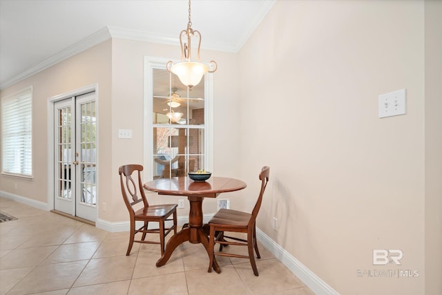 dining room with light tile patterned floors and crown molding