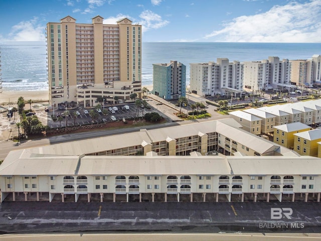 birds eye view of property with a water view and a beach view