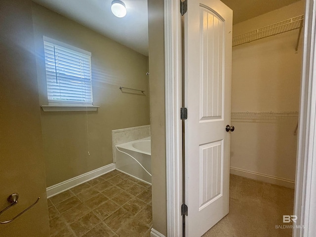 8185 Savage Loop, Theodore, AL 36582 - bathroom with a garden tub and a walk in closet
