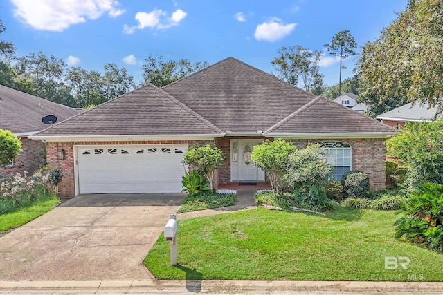 view of front of property with a garage and a front lawn