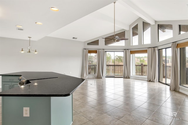 kitchen featuring hanging light fixtures, vaulted ceiling with beams, and ceiling fan with notable chandelier