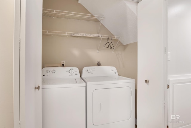 clothes washing area featuring washer and dryer