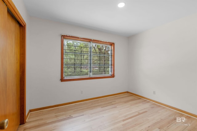 unfurnished bedroom with recessed lighting, light wood-style floors, a closet, and baseboards