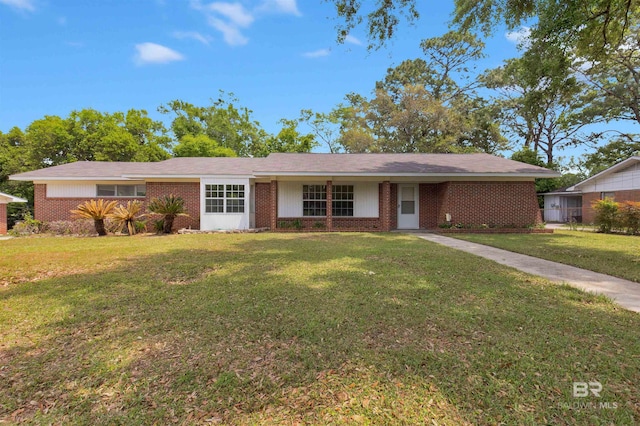 ranch-style house with brick siding and a front yard