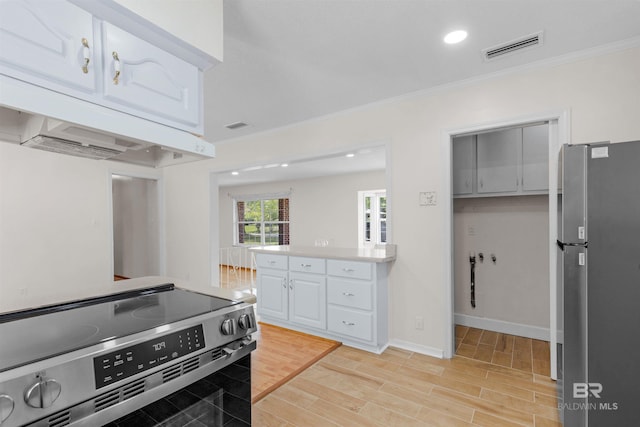 kitchen with white cabinets, visible vents, crown molding, and stainless steel appliances