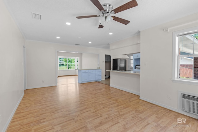unfurnished living room featuring light wood-style floors, visible vents, baseboards, and ceiling fan