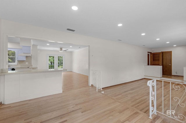 interior space with light wood-type flooring, a ceiling fan, visible vents, and recessed lighting