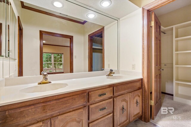 bathroom featuring a textured ceiling and vanity