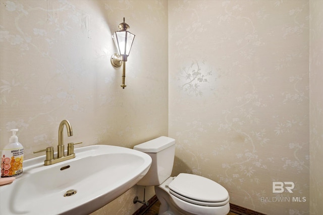 3761 Winford Rd, Mobile, AL 36619 - bathroom with wallpapered walls, toilet, and a sink