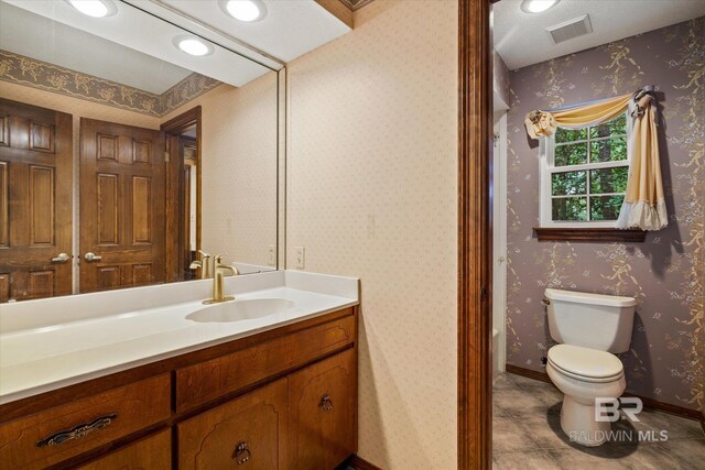 bathroom featuring toilet and vanity