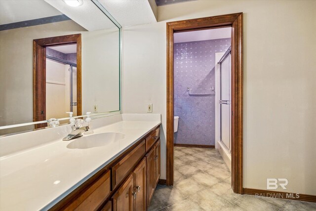 bathroom featuring vanity and a shower with shower door