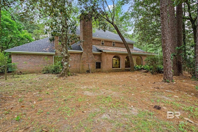 3761 Winford Rd, Mobile, AL 36619 - back of house with a chimney, brick siding, and roof with shingles