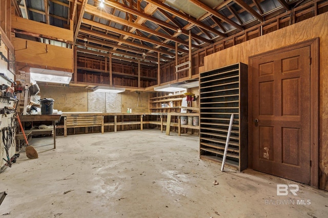 interior space featuring concrete flooring and a workshop area