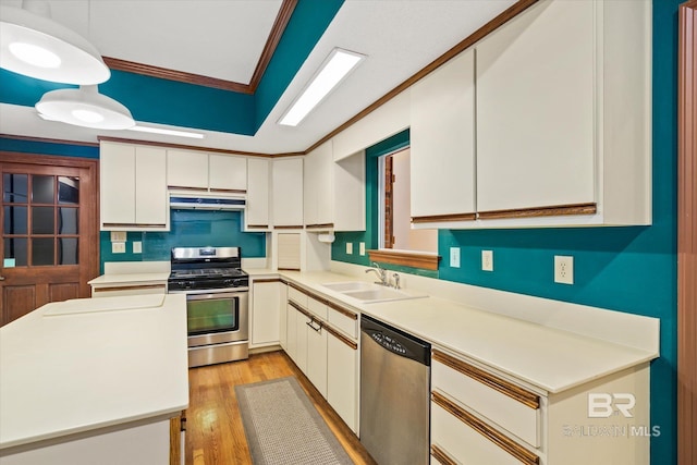 3761 Winford Rd, Mobile, AL 36619 - kitchen with crown molding, a sink, light wood finished floors, under cabinet range hood, and stainless steel appliances