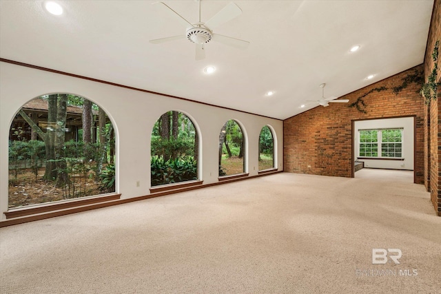 3761 Winford Rd, Mobile, AL 36619 - carpeted spare room featuring a healthy amount of sunlight, vaulted ceiling, a ceiling fan, and brick wall