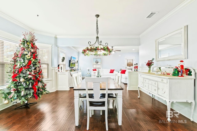 dining space with ornamental molding and dark wood-type flooring