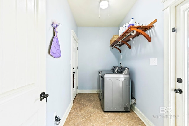 laundry area featuring light tile patterned floors and separate washer and dryer