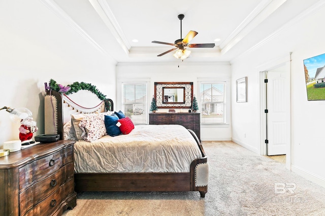 carpeted bedroom featuring ceiling fan, a raised ceiling, and ornamental molding