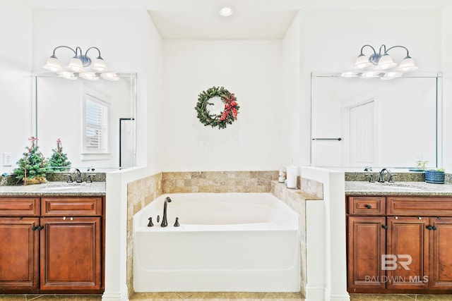 bathroom featuring a bath and vanity