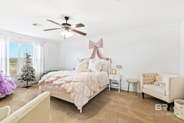 carpeted bedroom featuring ceiling fan and crown molding