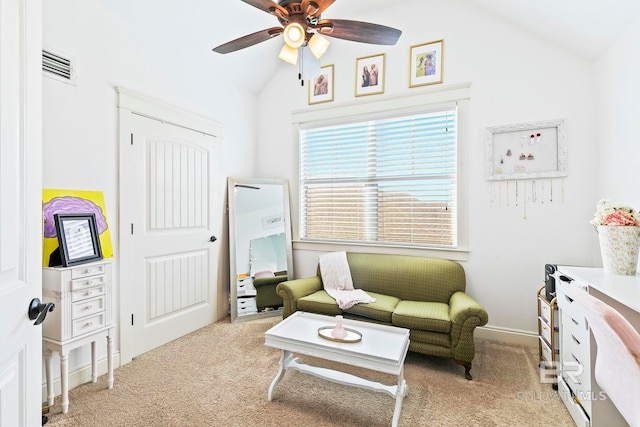 living area with light carpet, vaulted ceiling, and ceiling fan