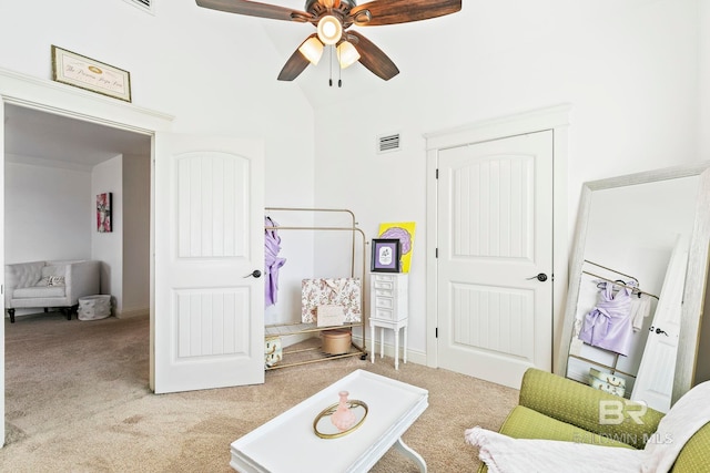 sitting room with light carpet, ceiling fan, and lofted ceiling