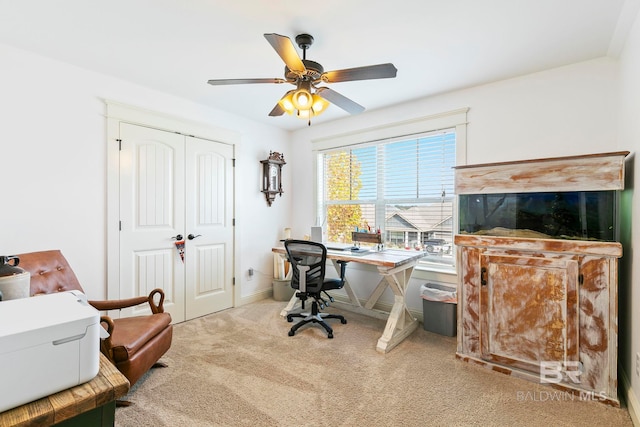 office featuring ceiling fan and light carpet