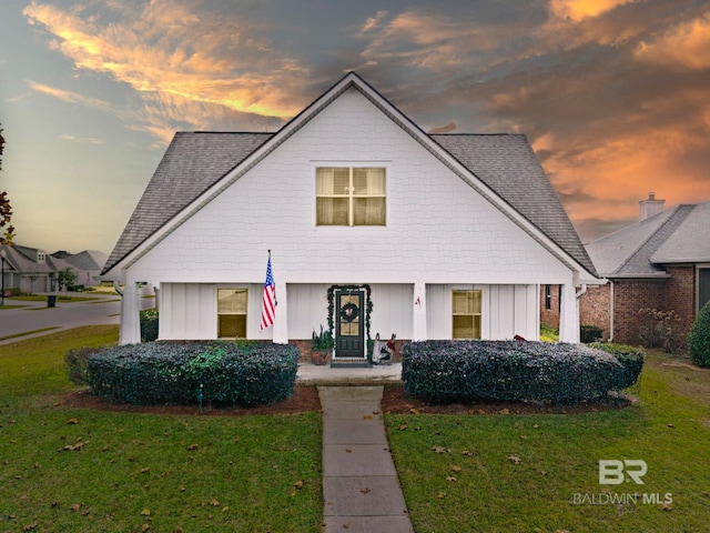 view of front of home with a yard and a porch