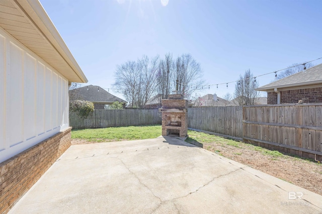 8856 Asphodel Ln, Daphne, AL 36526 - fenced backyard with a fireplace and a patio area