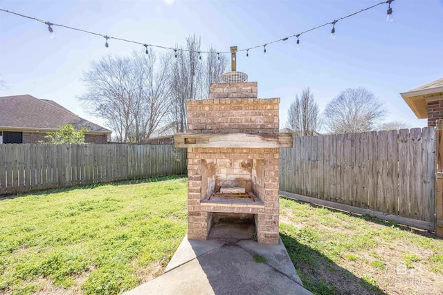 8856 Asphodel Ln, Daphne, AL 36526 - fenced backyard featuring an outdoor brick fireplace