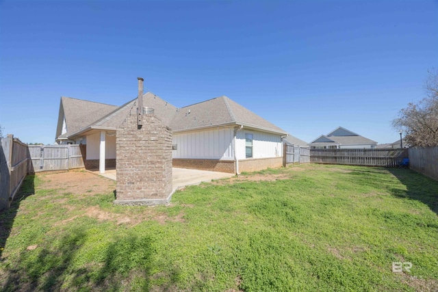 8856 Asphodel Ln, Daphne, AL 36526 - rear view of property with a fenced backyard, a shingled roof, and a patio