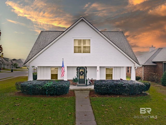 8856 Asphodel Ln, Daphne, AL 36526 - view of front facade featuring board and batten siding, a lawn, and a shingled roof