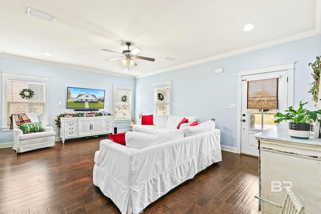 living room with crown molding, plenty of natural light, and dark hardwood / wood-style floors