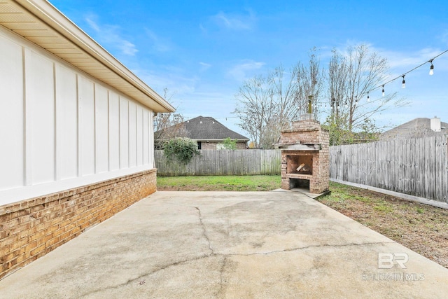 view of patio / terrace featuring an outdoor brick fireplace