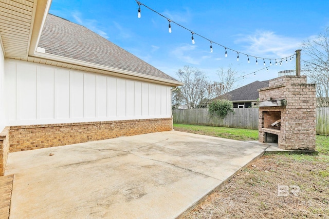 view of patio featuring an outdoor brick fireplace