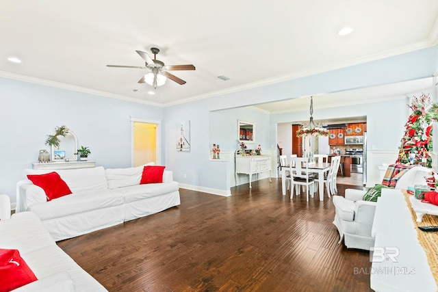 living room featuring ceiling fan with notable chandelier, dark hardwood / wood-style floors, and ornamental molding